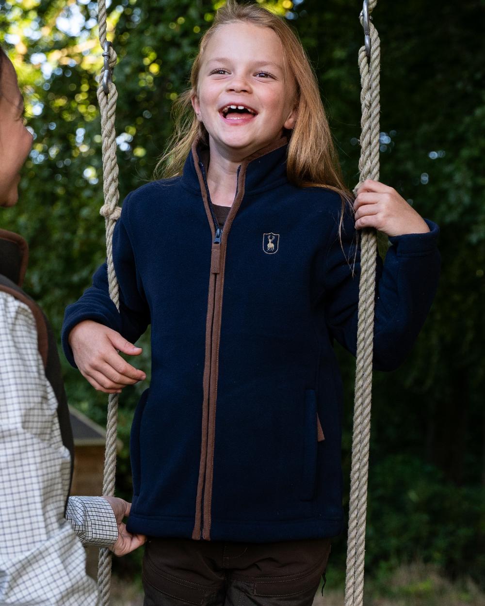 Dark Blue Coloured Deerhunter Youth Cumbria Fleece Jacket on forest background 