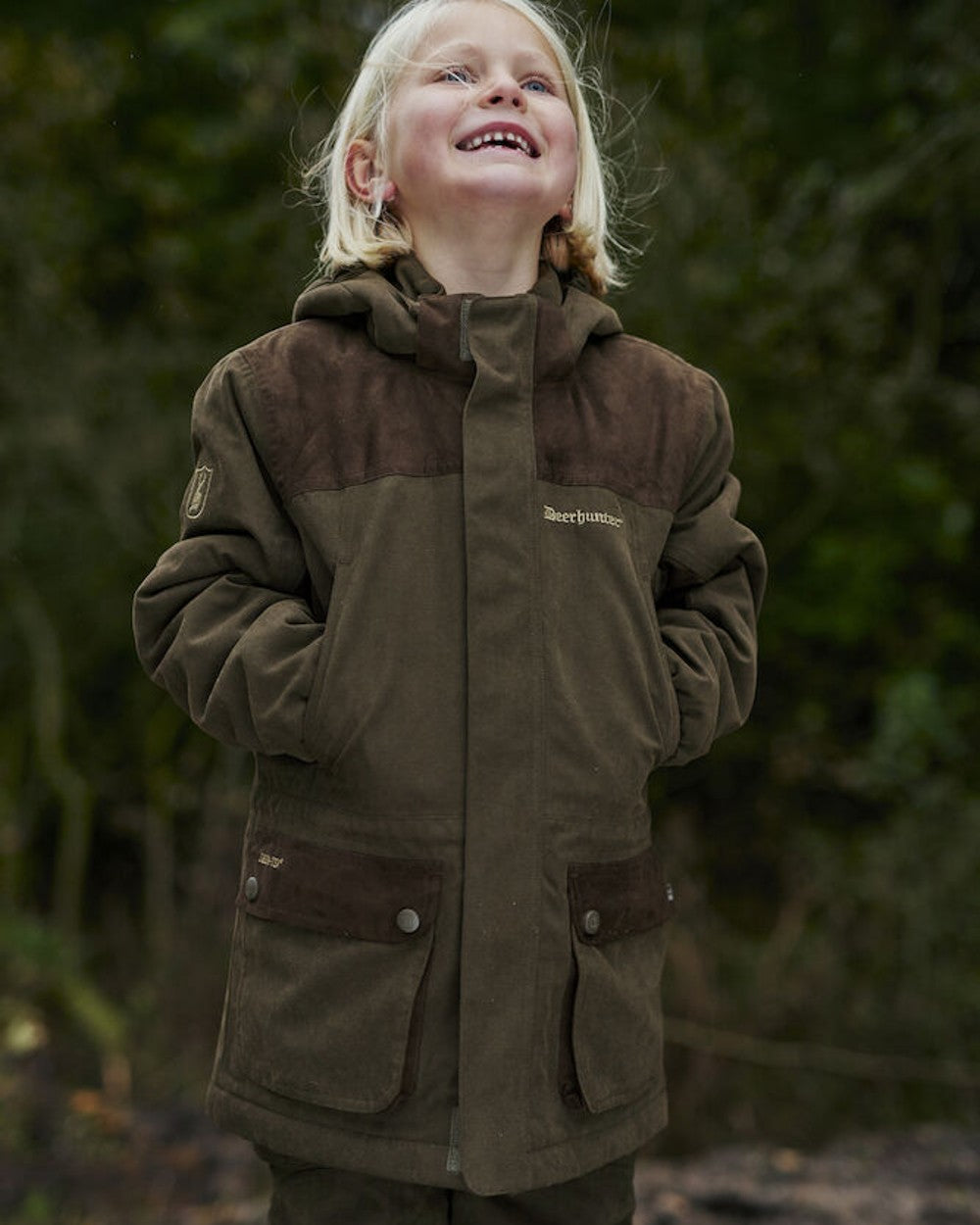 Tarmac Green coloured Deerhunter Youth Eagle Winter Jacket on Forest background 