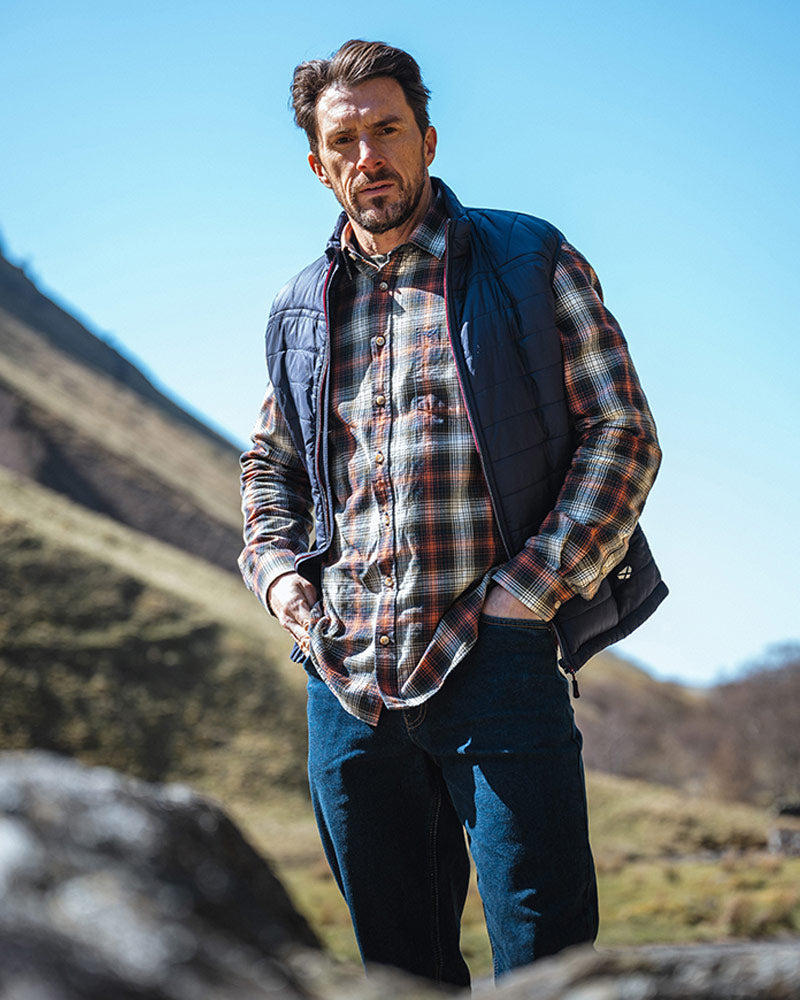 Male model wearing a Blue Hoggs of Fife Gilet on a natural background