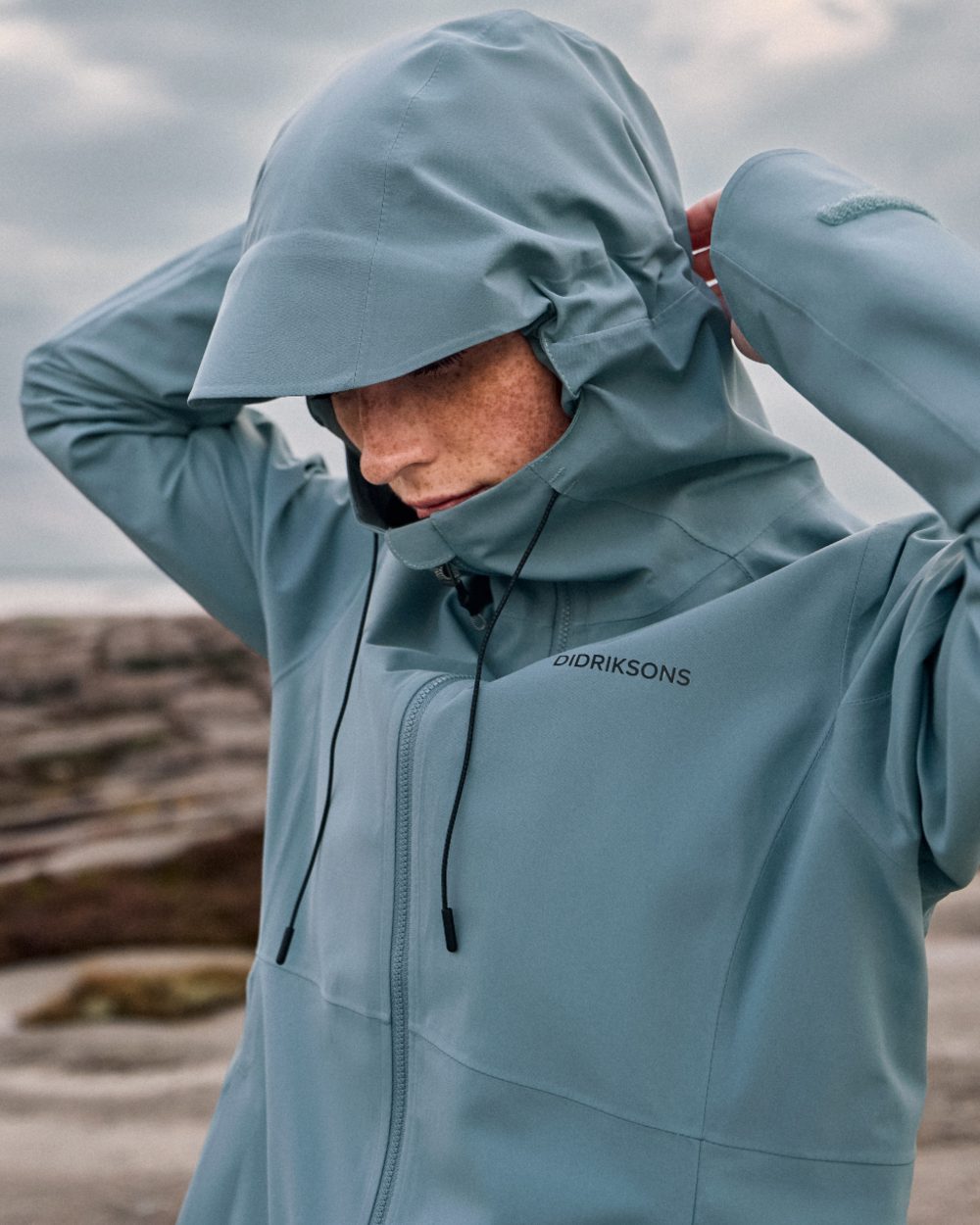 Factory Blue coloured Didriksons Bea Womens Parka 6 on sea background 