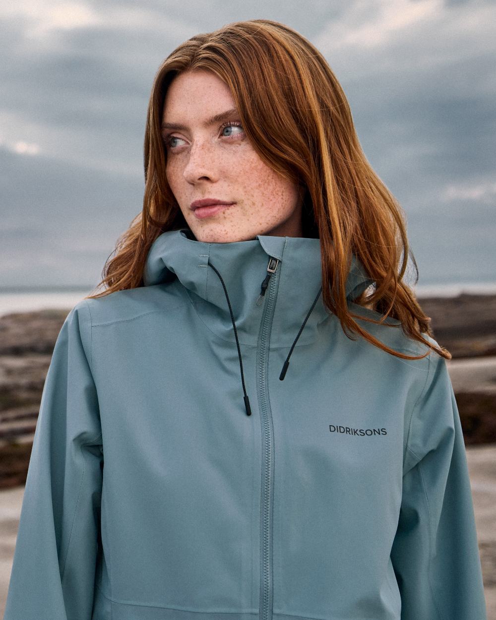 Factory Blue coloured Didriksons Bea Womens Parka 6 on sea background 