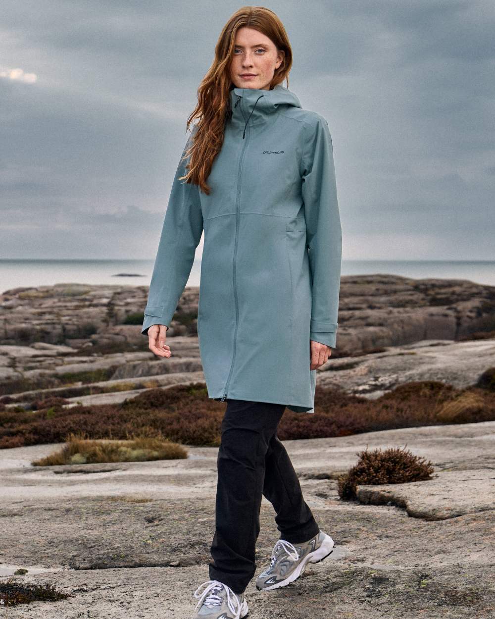 Factory Blue coloured Didriksons Bea Womens Parka 6 on sea background 