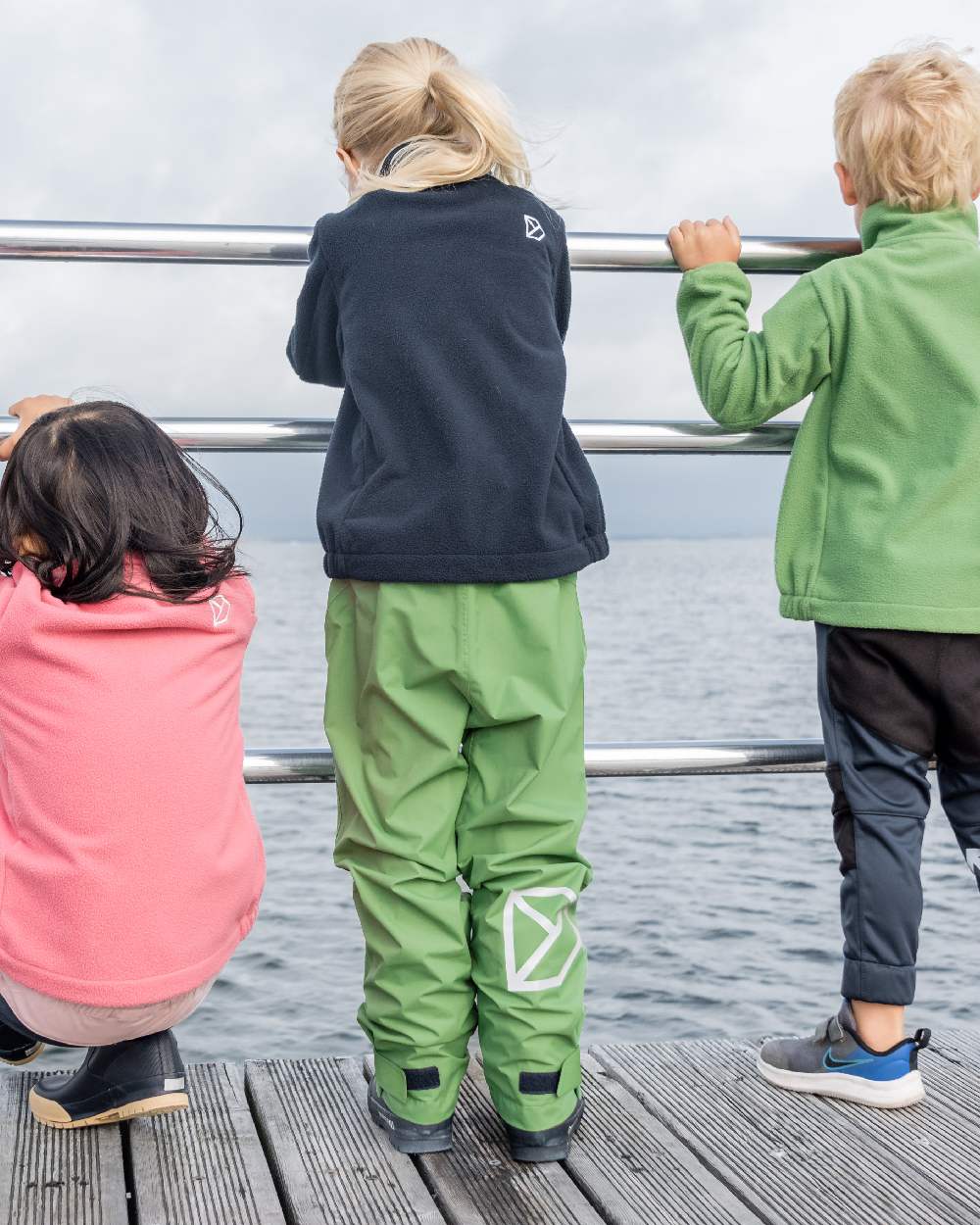 Algae Green coloured Didriksons Childrens Avan Pants on sea background 