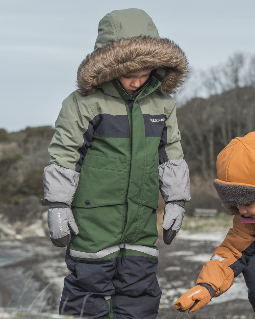 Silver coloured Didriksons Childrens Biggles Reflection Mittens on sea background 