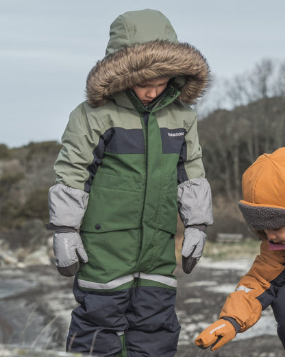Silver coloured Didriksons Childrens Biggles Reflection Mittens on sea background 