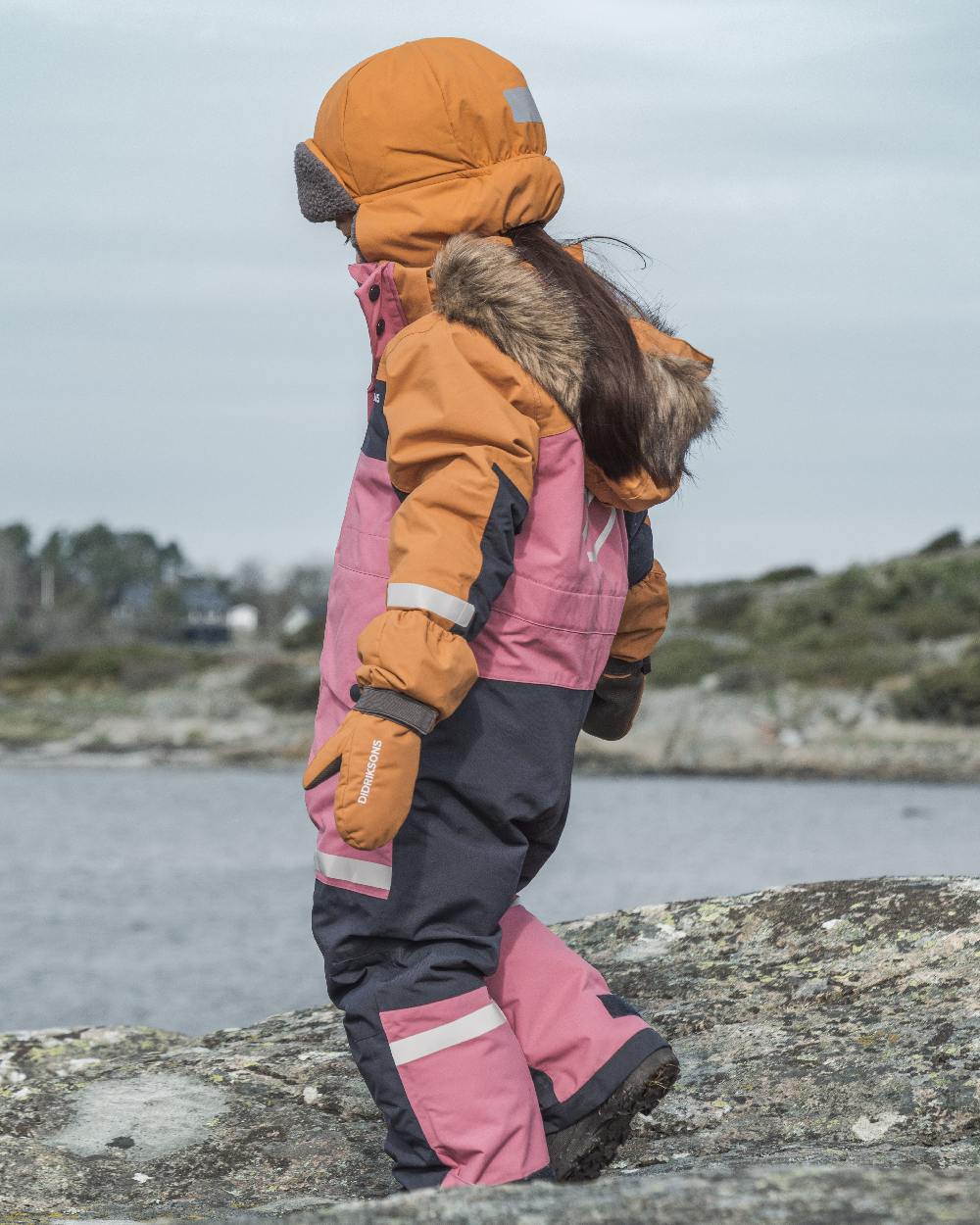 Heather Pink Coloured Didriksons Childrens Bjärven Coveralls on outdoor background 
