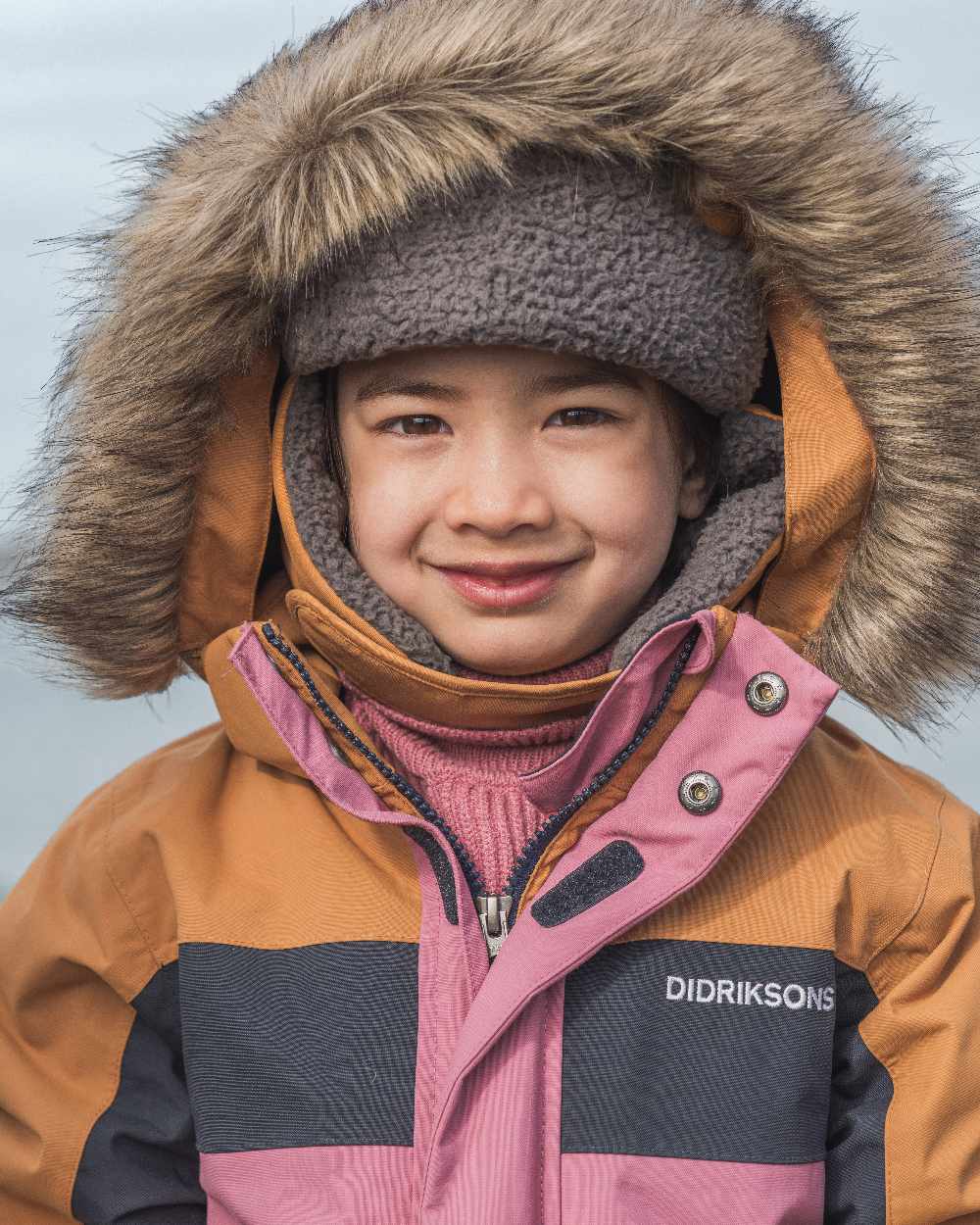 Heather Pink Coloured Didriksons Childrens Bjärven Coveralls on outdoor background 