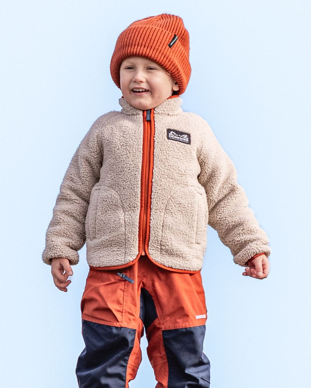 Beach Beige Rust coloured Didriksons Childrens Gibbs Full Zip Jacket 2 on beach background 