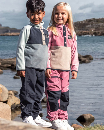 Heather Pink coloured Didriksons Childrens Monte Half Button Fleece 5 on sea background 