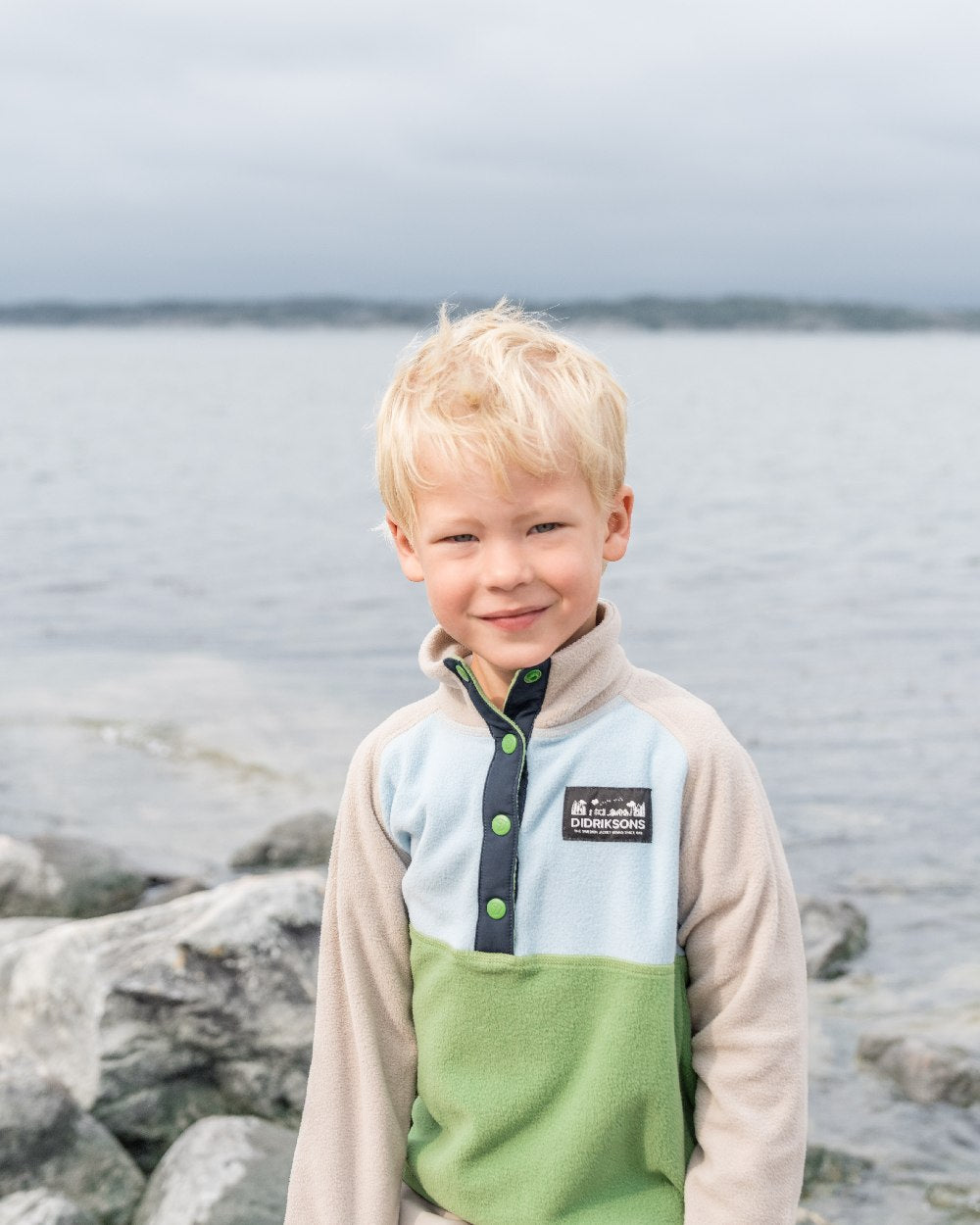 Algae Green coloured Didriksons Childrens Monte Half Button Fleece 4 on coastal background 