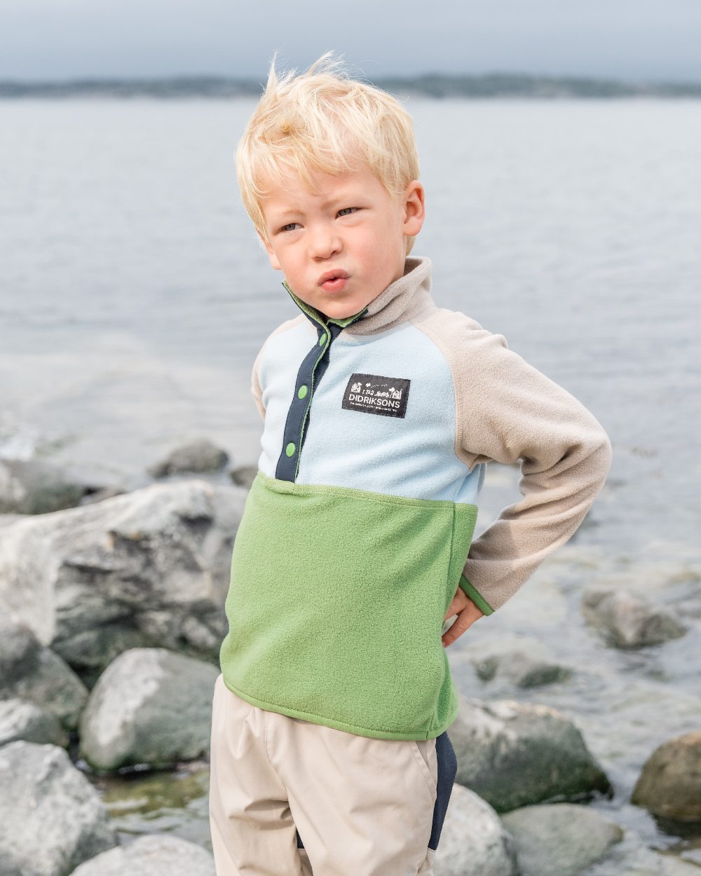 Algae Green coloured Didriksons Childrens Monte Half Button Fleece 4 on coastal background 