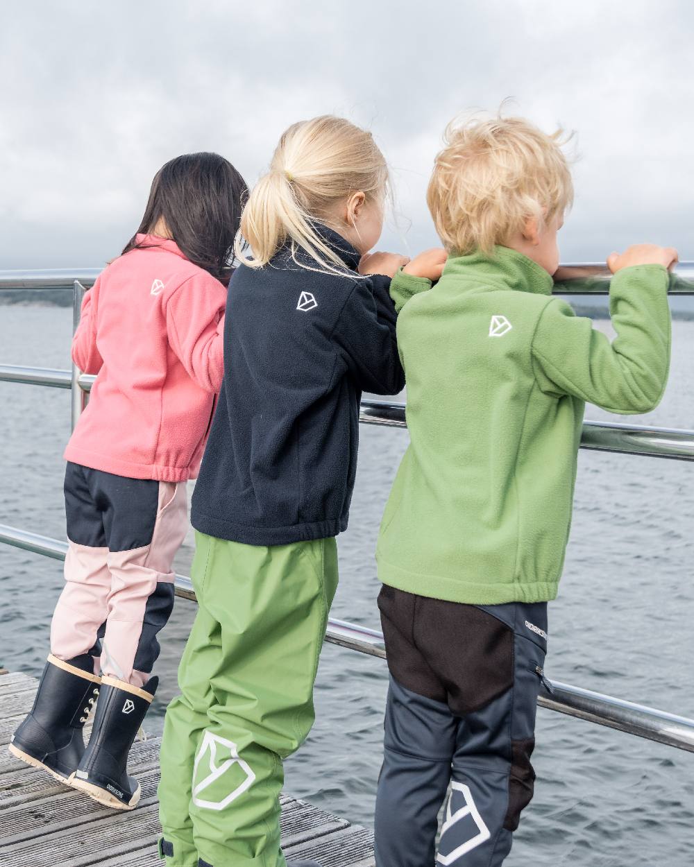 Algae Green coloured Didriksons Childrens Muskot Jacket on sea background 