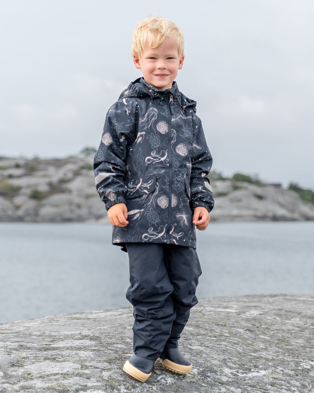 Ocean Navy coloured Didriksons Childrens Norma Printed Jacket on sea background 