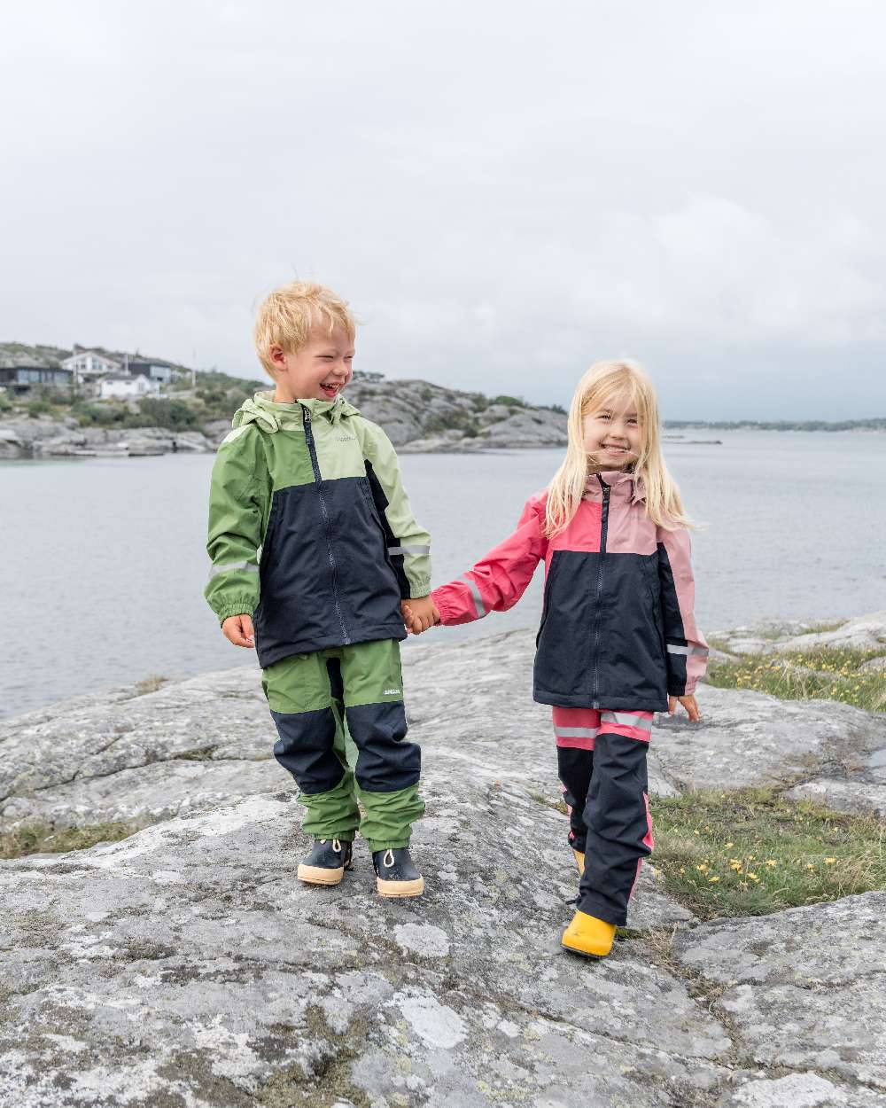 Light Algae Green coloured Didriksons Childrens Pilvi Jacket on coastal background 