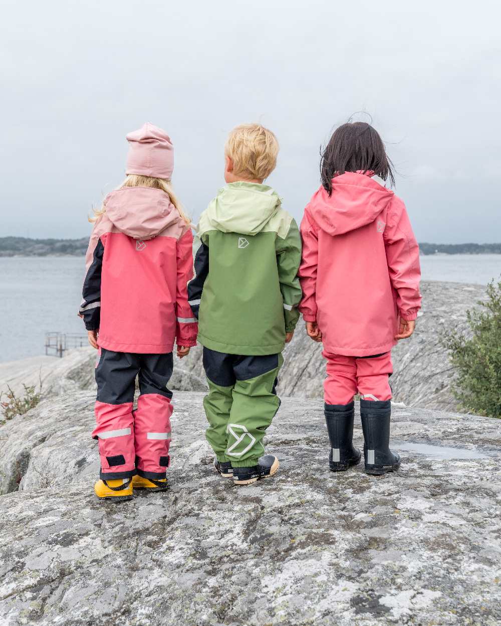 Light Algae Green coloured Didriksons Childrens Pilvi Jacket on coastal background 
