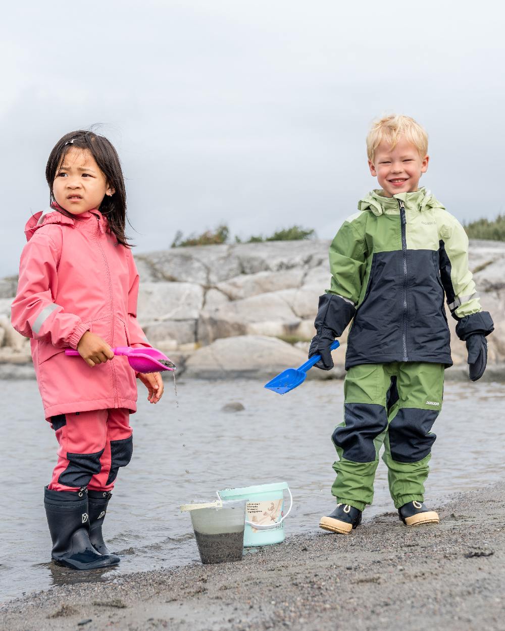 Light Algae Green coloured Didriksons Childrens Pilvi Jacket on coastal background 