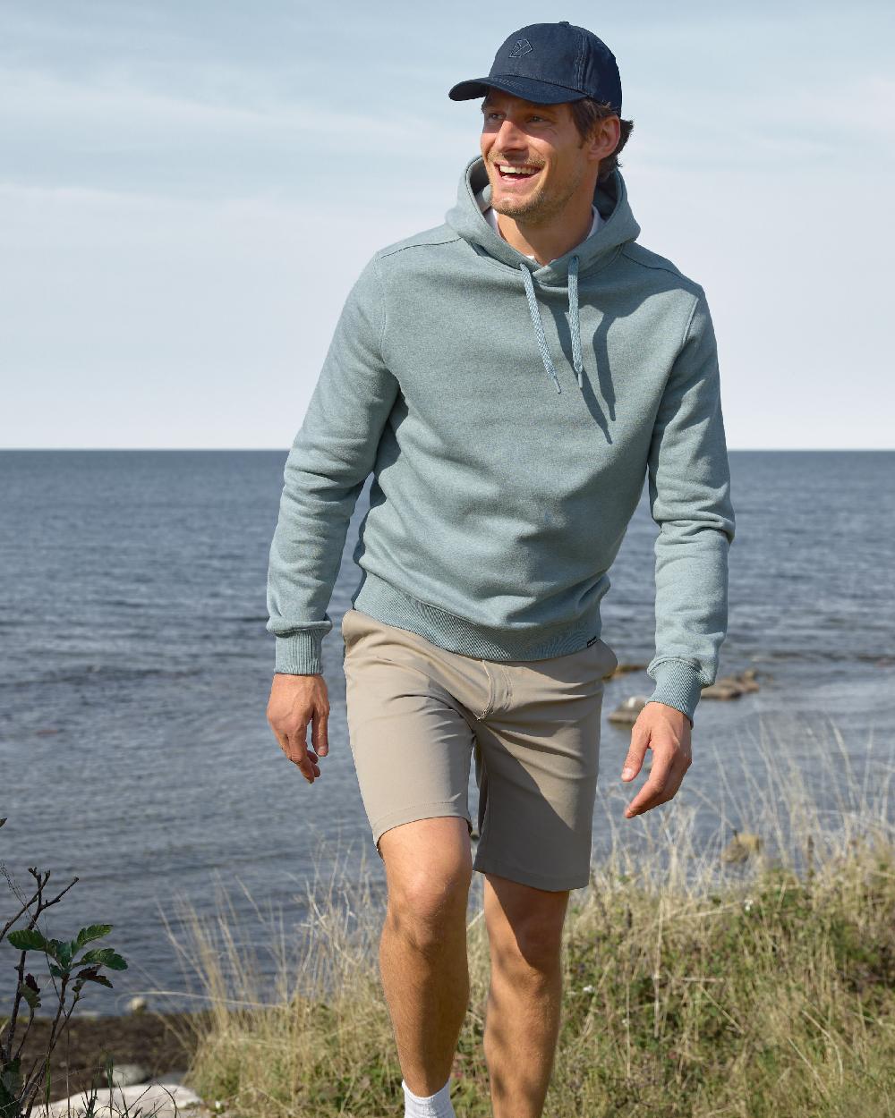 Dark Night Blue coloured Didriksons Derin Cap 2 on sea background 