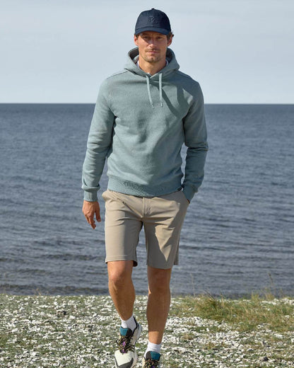 Dark Night Blue coloured Didriksons Derin Cap 2 on sea background 