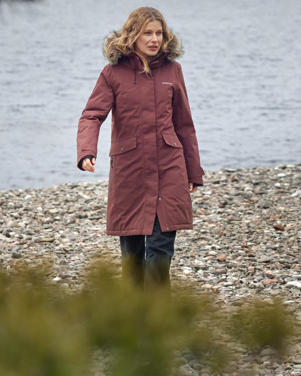 Old Rust Coloured Didriksons Erika Ladies Padded Waterproof Parka 3 On A Coastal Background 