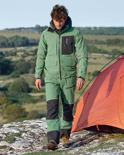 Dark Moss coloured Didriksons Fractus Waterproof Jacket on sea background 