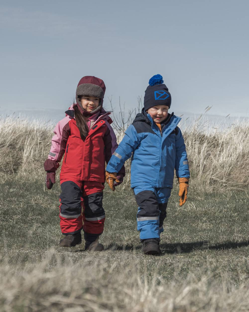Sapphire Blue Coloured Didriksons Kids Skare Set on mountain background 
