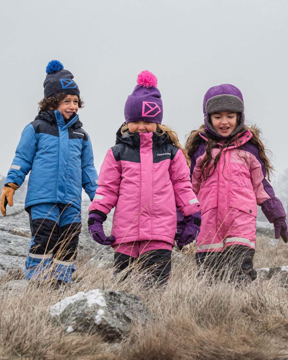 Sweet Pink Coloured Didriksons Kids Skare Set on mountain background 
