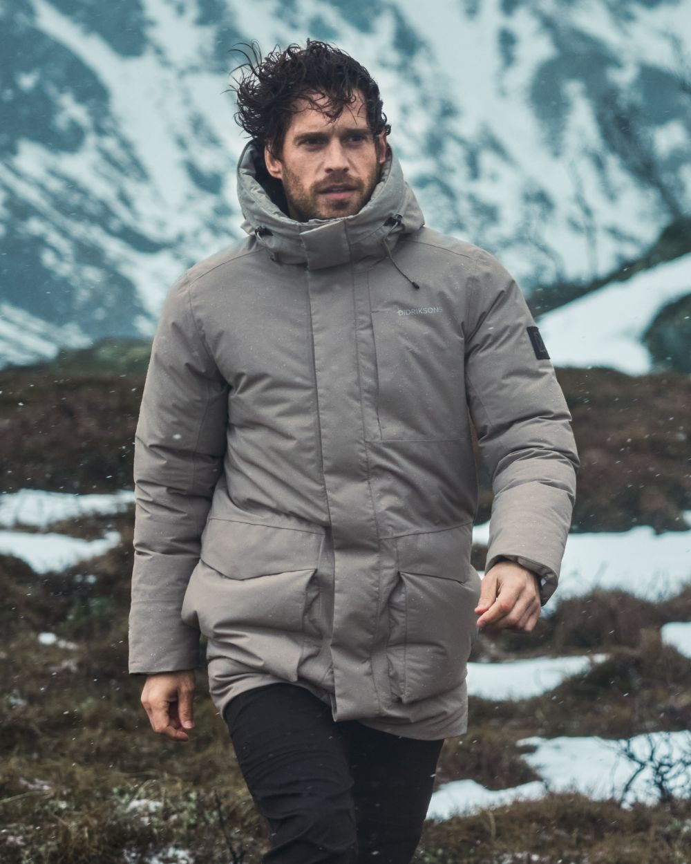 Ash Brown coloured Didriksons Mens Akilles Parka II on mountain background 