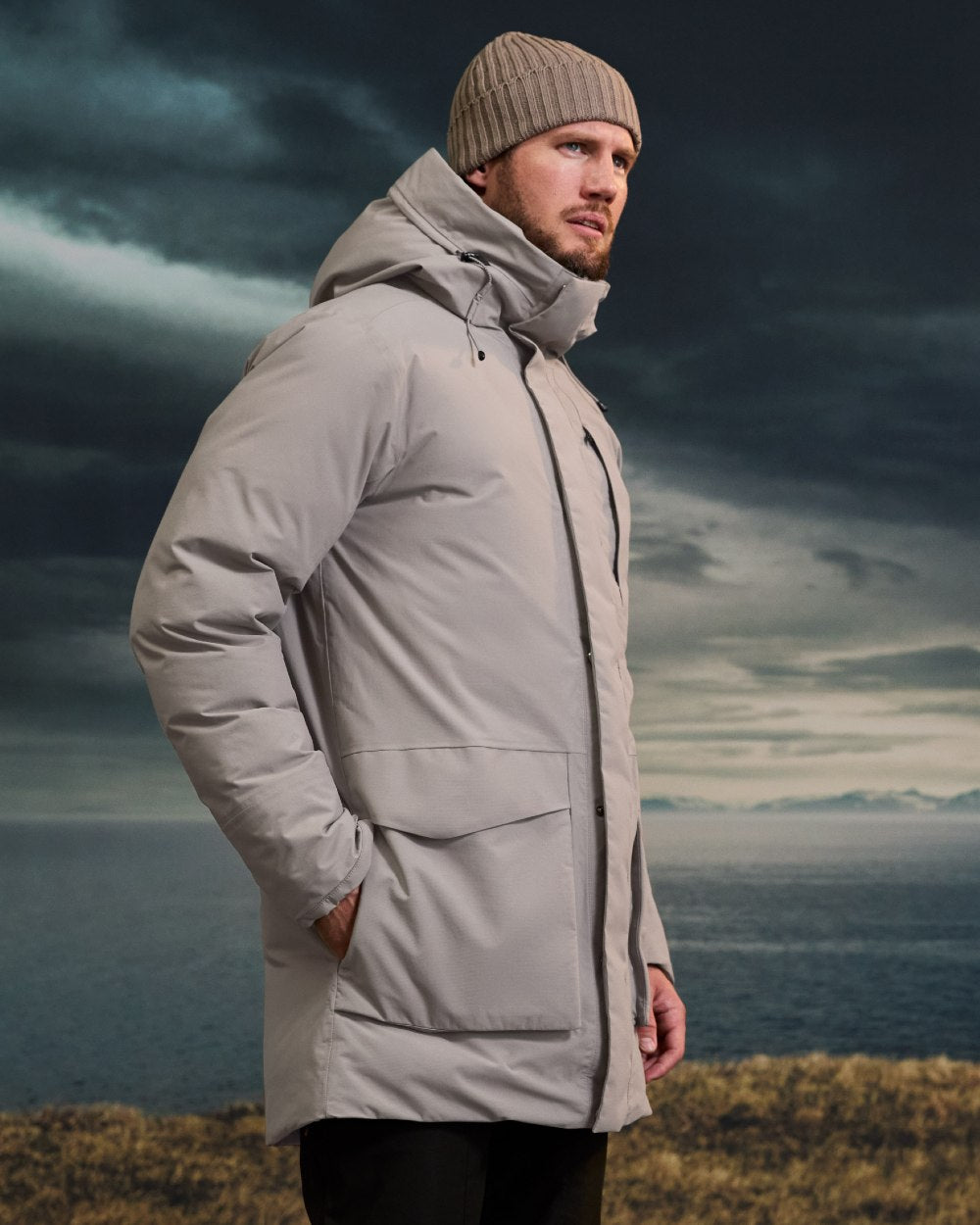 Ash Brown coloured Didriksons Mens Akilles Parka II on sea background 