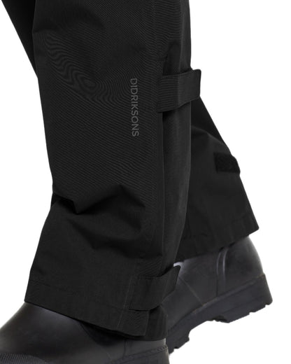Black coloured Didriksons Mens Grit Rain Pants on white background 
