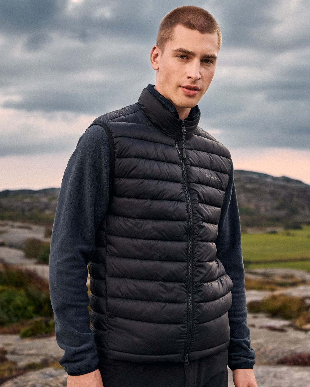 Black coloured Didriksons Mens Marino Vest on mountain background 