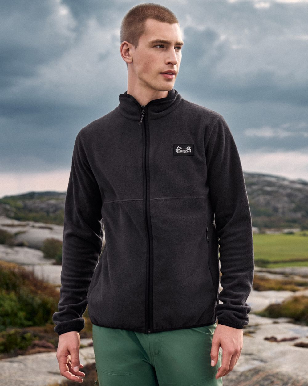 Graphite coloured Didriksons Mens Vito Full Zip Fleece on mountain background 