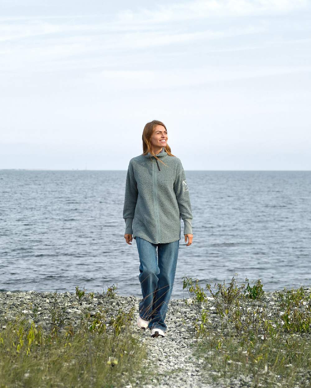 Factory Blue coloured Didriksons Full-Zip Jacket on coastal background 