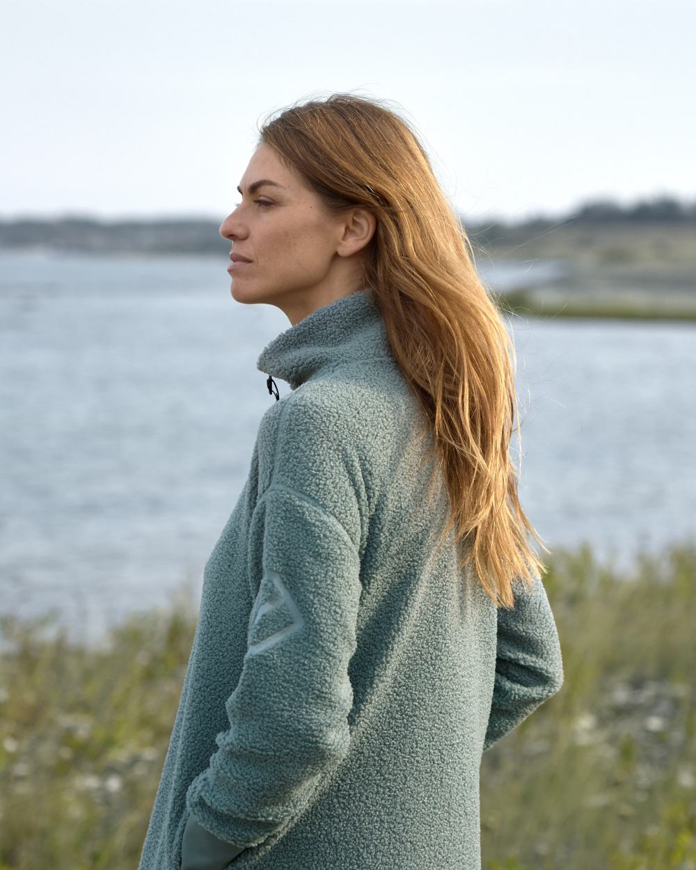 Factory Blue coloured Didriksons Full-Zip Jacket on coastal background 