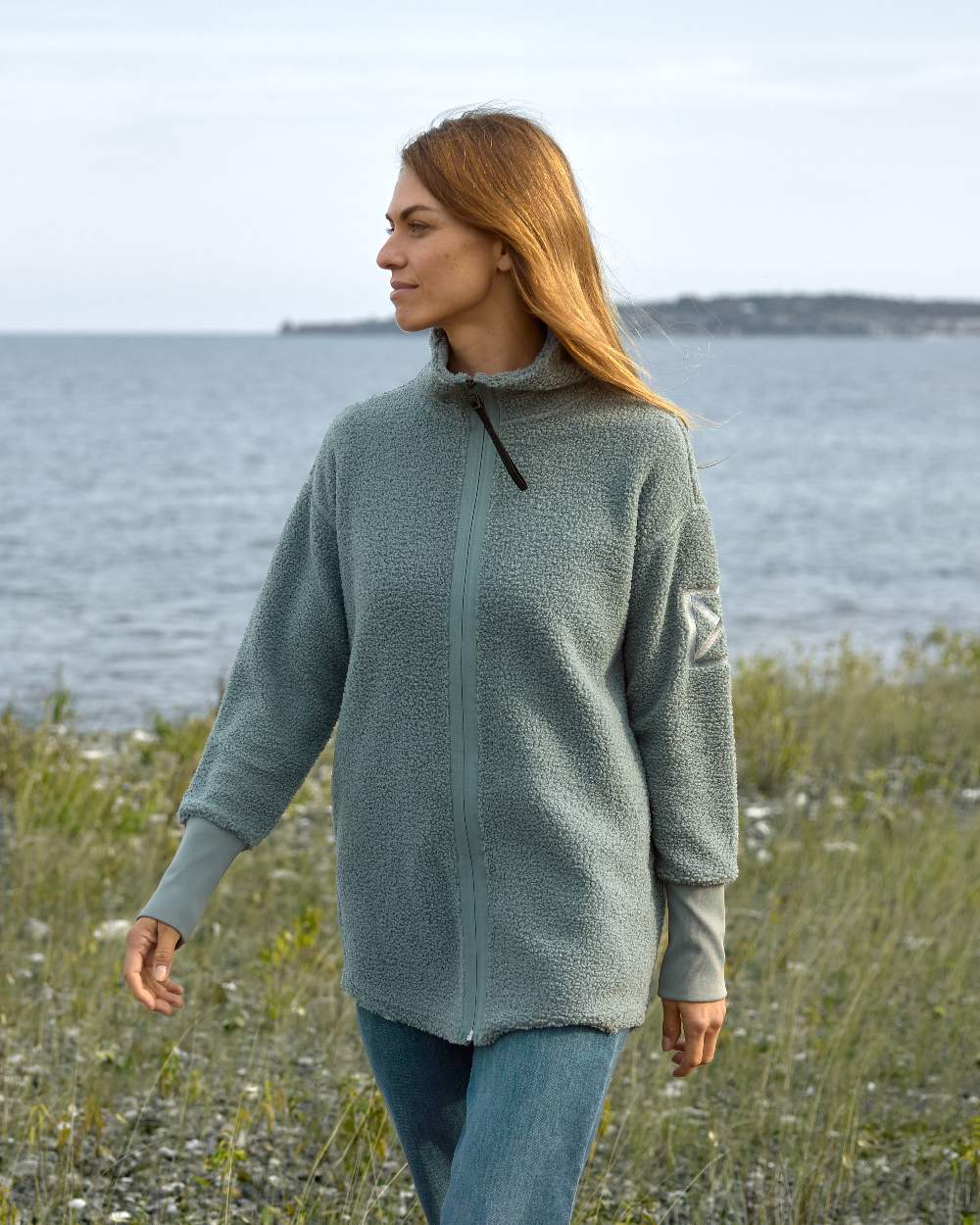 Factory Blue coloured Didriksons Full-Zip Jacket on coastal background 