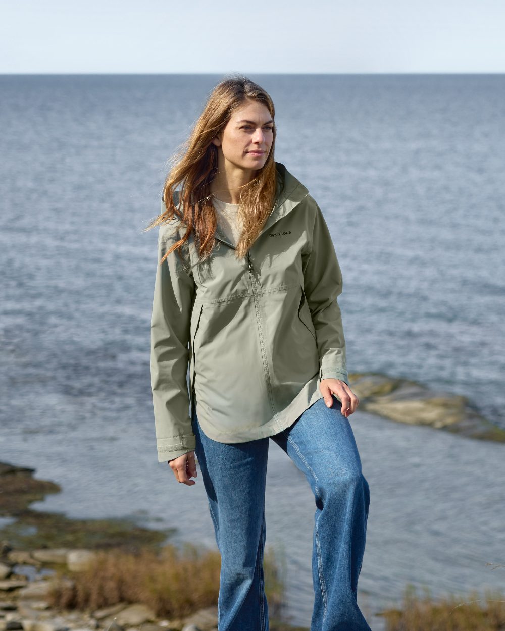 Wilted Leaf coloured Didriksons Tilde Womens Jacket on coastal background 