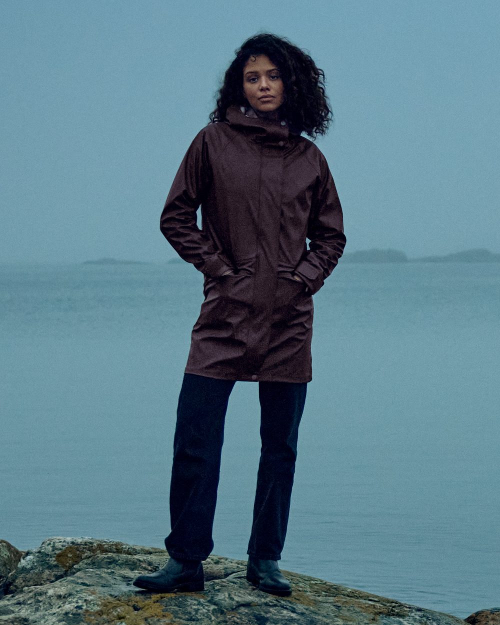 Old Rust coloured Didriksons Womens Elly Parka 4 on sea background 