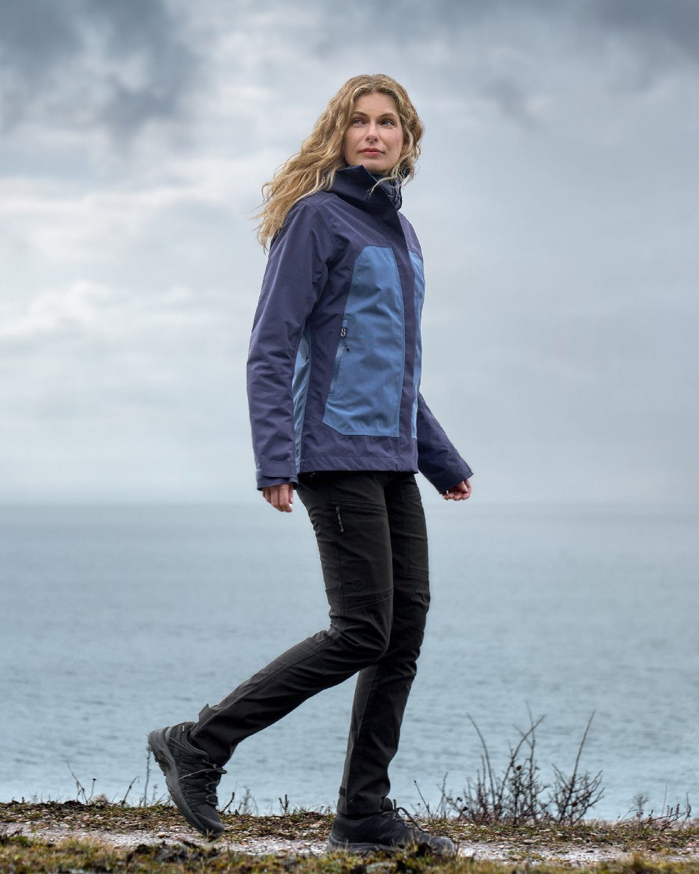 Blue Arcad coloured Didriksons Womens Grit Jacket 3 on sea background 