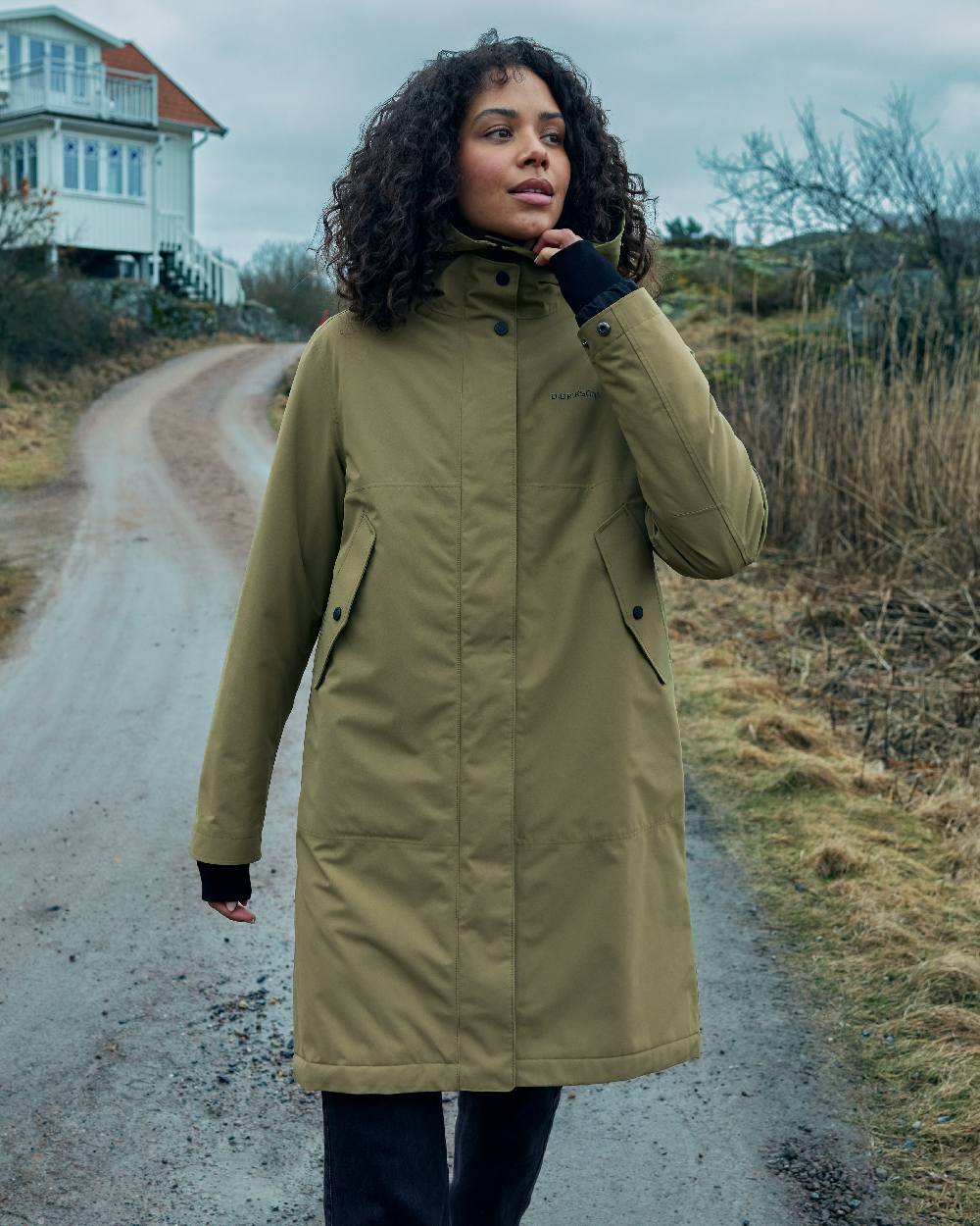 Olive Green Coloured Didriksons Womens Iris Parka on outdoor background 