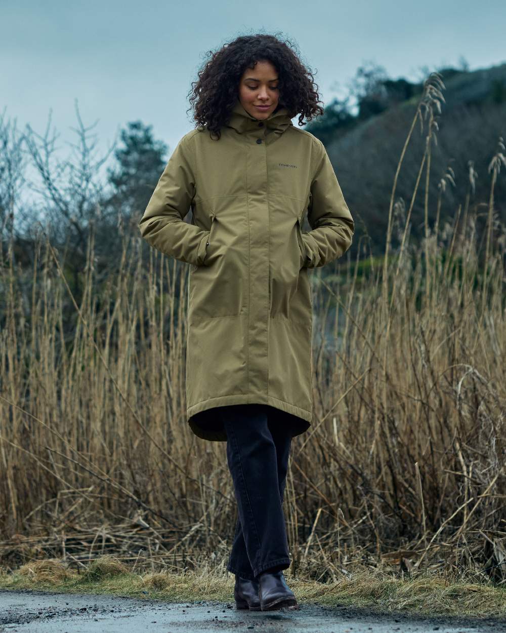 Olive Green Coloured Didriksons Womens Iris Parka on outdoor background 