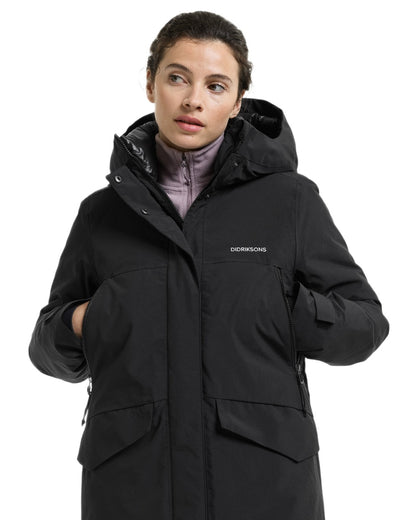Black coloured Didriksons Womens Neja Long Parka on white background 