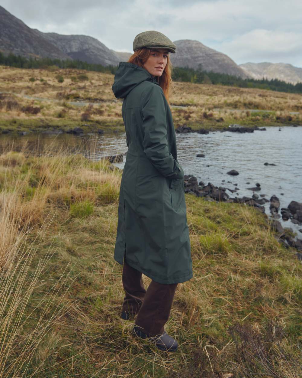 Pesto Coloured Dubarry Alderford Waterproof Coat on mountain background 