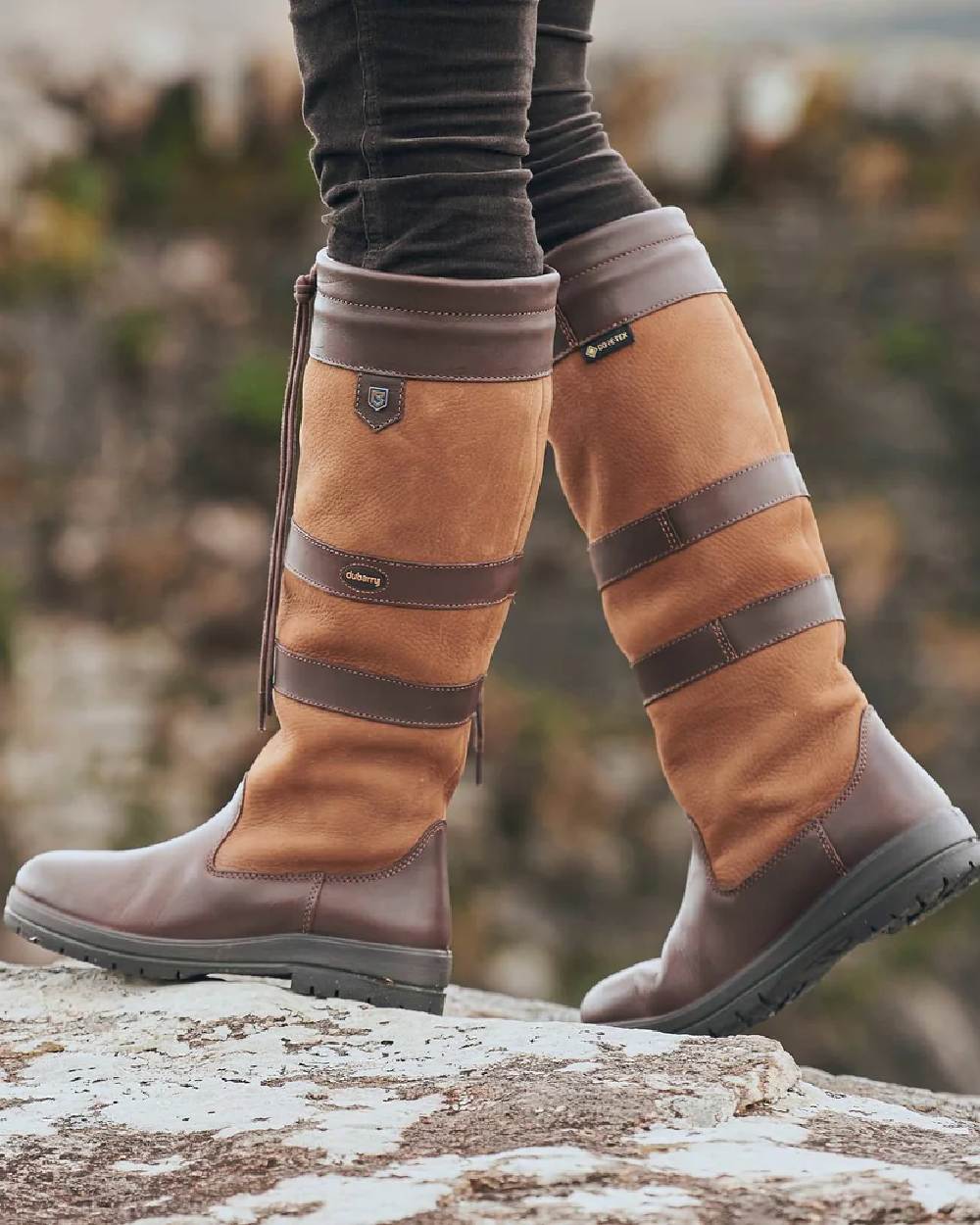 Brown coloured Dubarry Galway Country Boots on rock background 