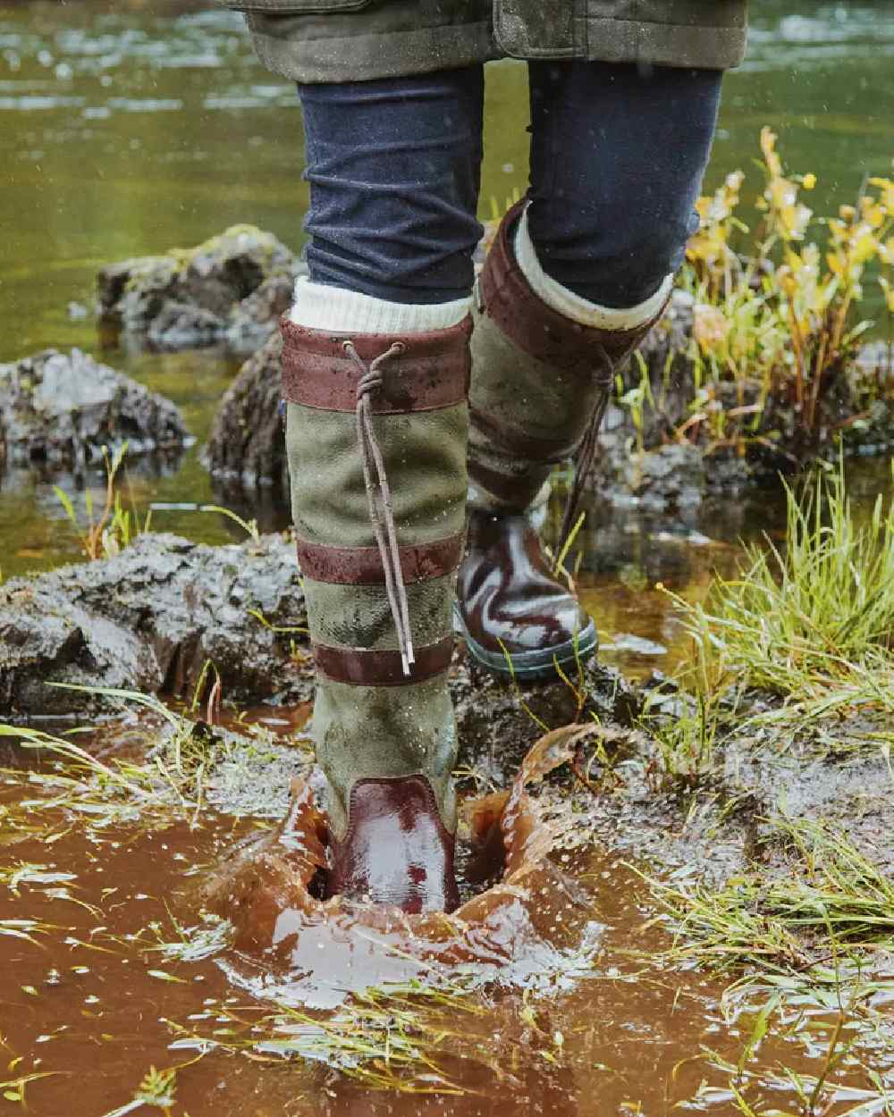 Ivy coloured Dubarry Galway Country Boots on mud background 