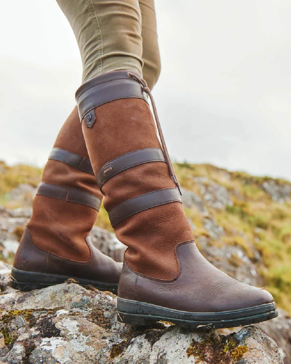 Walnut coloured Dubarry Galway Country Boots on rock background 