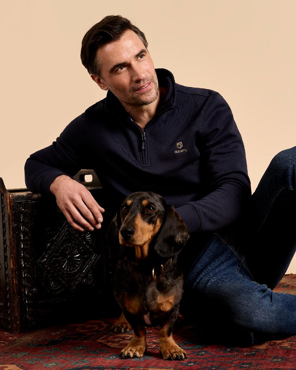 Navy coloured Dubarry Mens Boyce Zip Neck Sweater on indoor background 