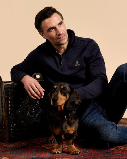 Navy coloured Dubarry Mens Boyce Zip Neck Sweater on indoor background 