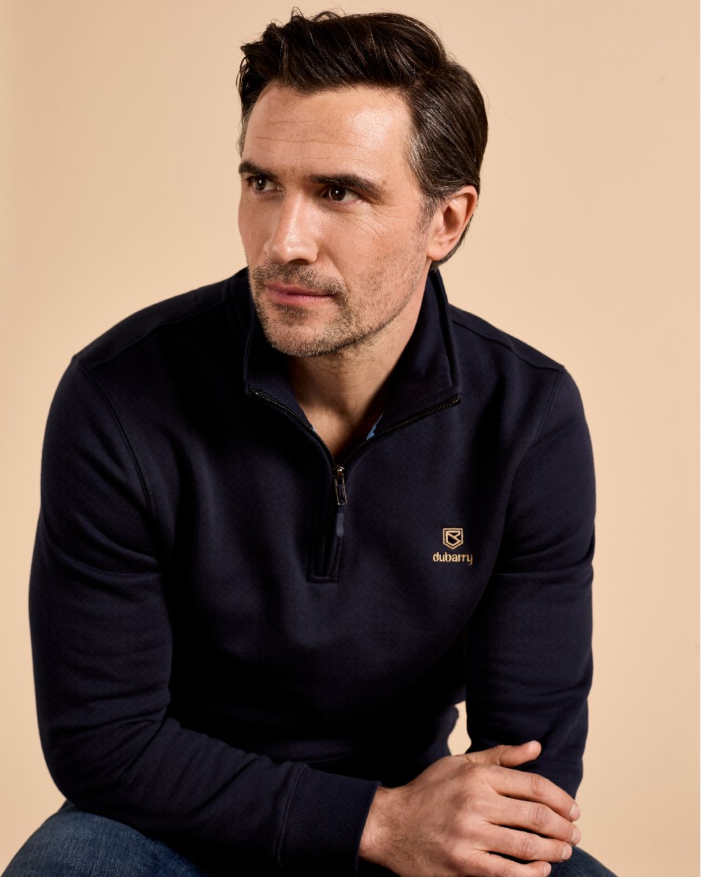 Navy coloured Dubarry Mens Boyce Zip Neck Sweater on indoor background 