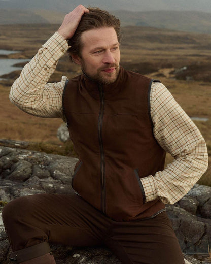 Walnut coloured Dubarry Mens Dunhill Leather Gilet on mountain background 