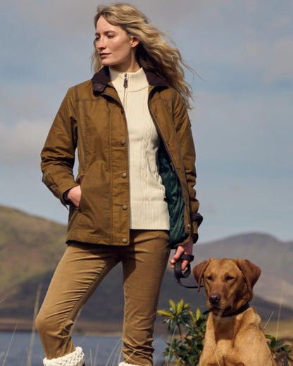 Ochre coloured Dubarry Mountrath Waxed Jacket on mountain background 