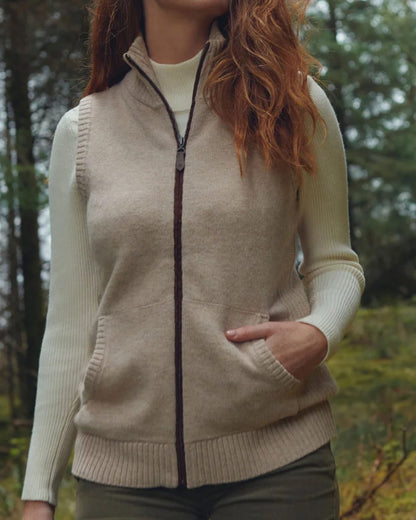 Oat Coloured Dubarry Sheedy Knit Bodywarmer on forest background 